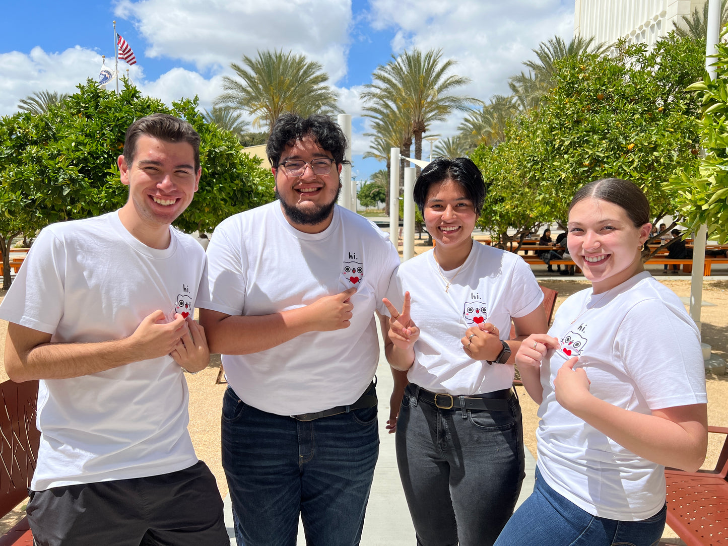 four people posing with their merchandise